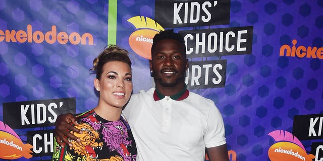 Chelsie Kyriss (L) and NFL player Antonio Brown pose backstage at the Nickelodeon Kids' Choice Sports 2018 at Barker Hangar on July 19, 2018 in Santa Monica, California. 