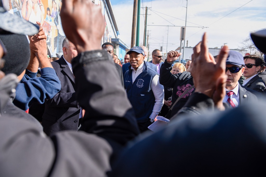 Adams visiting with migrants outside the Casa Sacred Heart migrant shelter in El Paso.