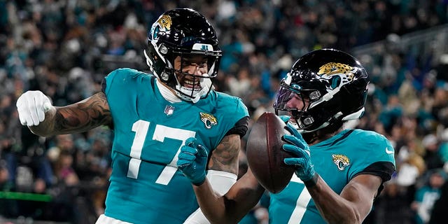 Jacksonville Jaguars wide receiver Zay Jones (7) celebrates his touchdown with tight end Evan Engram (17) during the second of an NFL wild-card football game against the Los Angeles Chargers, Saturday, Jan. 14, 2023, in Jacksonville, Fla. 
