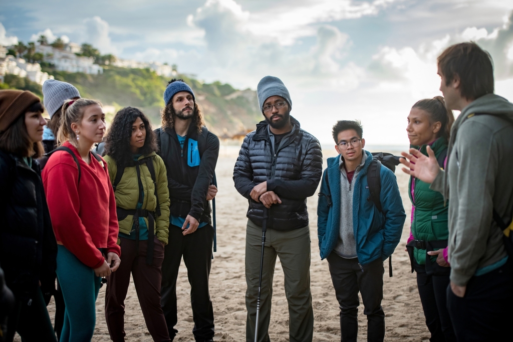 Chris Sharma mentors the other climbers: Alice Hafer, Robyn Michelle Ragins, Maiza Lima, Decco, Mario Randall Stanley, and Cat Runner. 