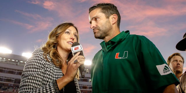 ESPN sideline reporter Allison Williams interviews head coach Manny Diaz of the Miami Hurricanes after a game against the Florida State Seminoles at Doak Campbell Stadium on Bobby Bowden Field Nov. 2, 2019, in Tallahassee, Fla.  