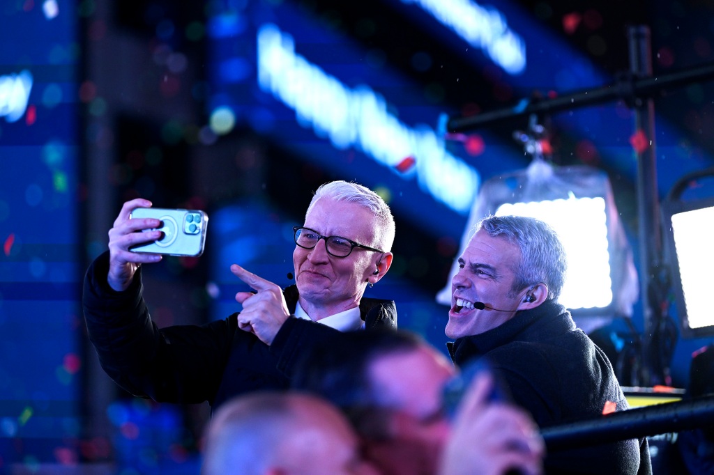 Anderson Cooper and Andy Cohen pose for a selfie during the Times Square New Year's Eve 2023 Celebration 