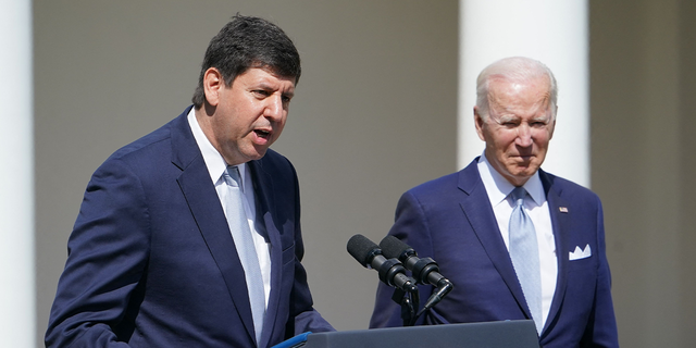 US President Joe Biden (R) listens as Steve Dettelbach, nominee for Director of the Bureau of Alcohol, Tobacco, Firearms, and Explosives, speaks on measures to combat gun crime from the Rose Garden of the White House in Washington, DC, on April 11, 2022.