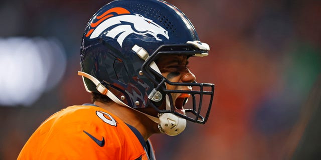 Russell Wilson #3 of the Denver Broncos celebrates after throwing a touchdown pass during the fourth quarter against the Los Angeles Chargers at Empower Field At Mile High on January 08, 2023 in Denver, Colorado.