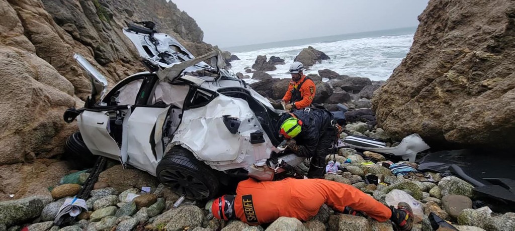 The mangled Tesla after it plunged off a California cliff.