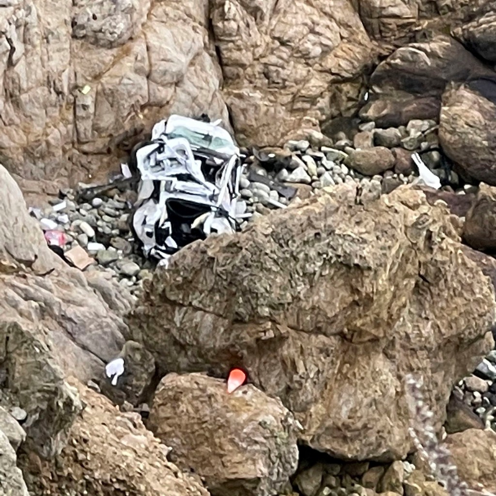 The mangled Tesla after it plunged off a California cliff.