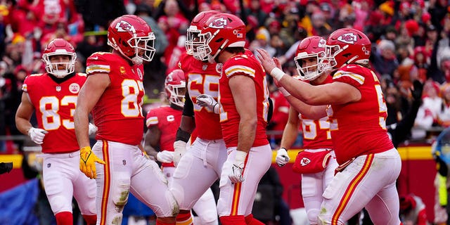 Travis Kelce (87) of the Kansas City Chiefs celebrates with his teammates after scoring an 8-yard touchdown against the Jacksonville Jaguars during the first quarter in an AFC divisional playoff game at Arrowhead Stadium Jan. 21, 2023, in Kansas City, Mo. 