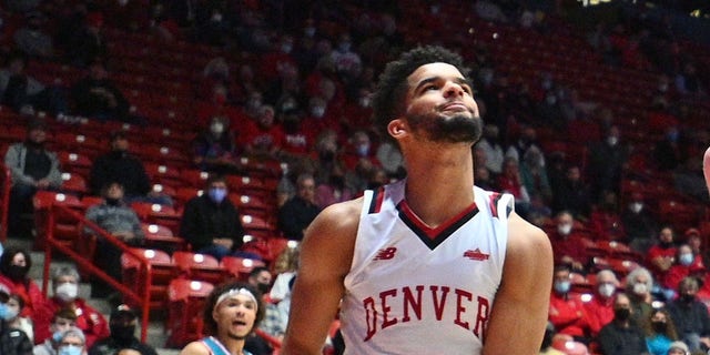 Sebastian Forsling #3 of the New Mexico Lobos dunks against Coban Porter #5, Taelyr Gatlin #4 and KJ Hunt #2 of the Denver Pioneers during their game at The Pit on December 9, 2021, in Albuquerque, New Mexico.