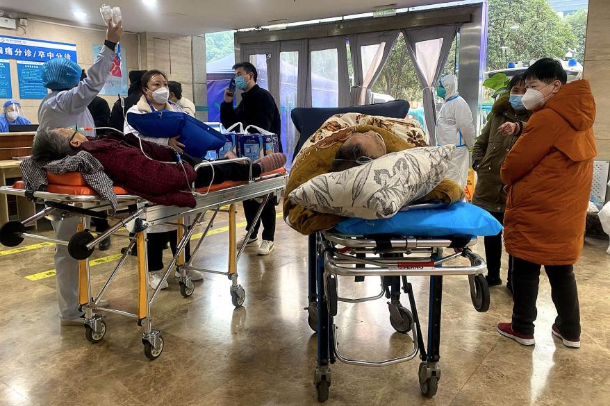 This picture shows Covid-19 patients on stretchers in the emergency ward of the First Affiliated Hospital of Chongqing Medical University in China's southwestern city of Chongqing.