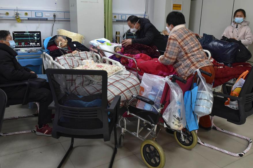 Family members look after their elderly relatives with COVID symptoms at the emergency ward of a hospital in Fuyang.