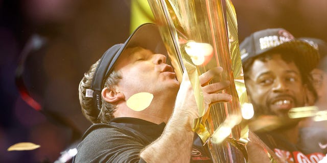 Head coach Kirby Smart of the Georgia Bulldogs kisses the National Championship trophy after defeating the TCU Horned Frogs in the College Football Playoff National Championship game at SoFi Stadium on January 09, 2023 in Inglewood, California. Georgia defeated TCU 65-7.