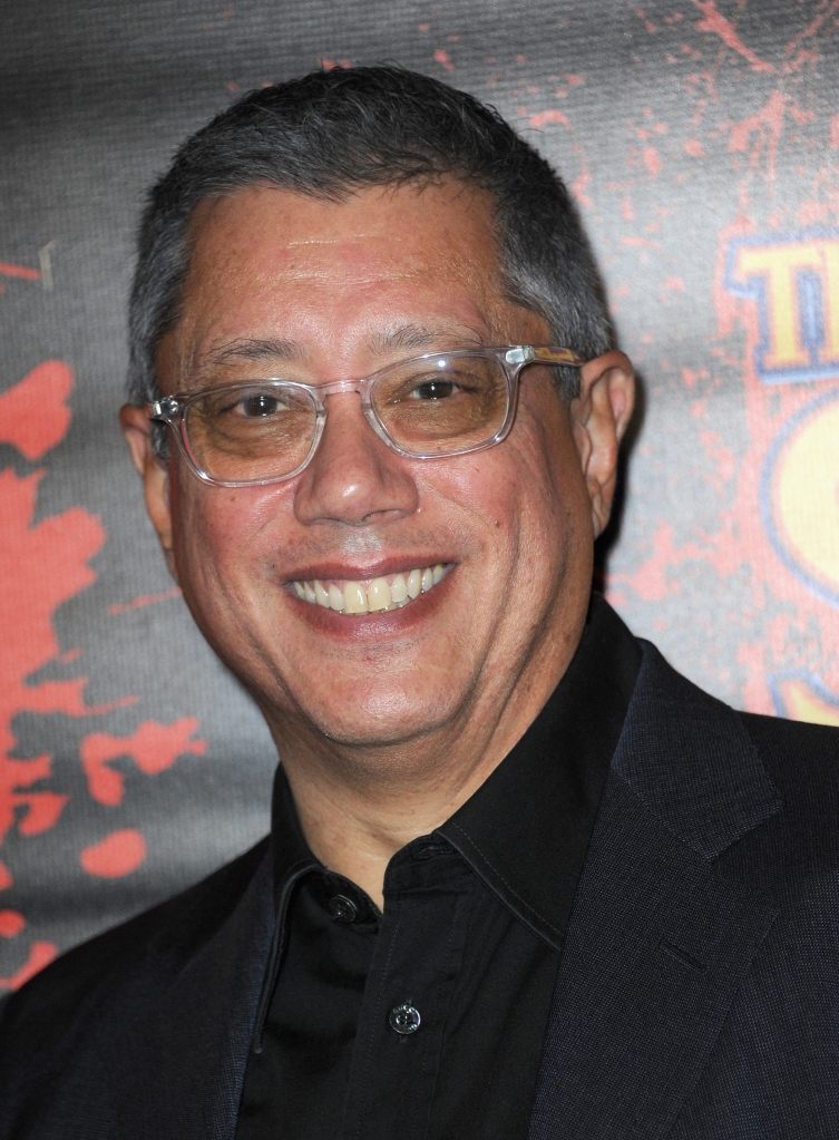 Photo of "The Ark" creator Dean Devlin. He's smiling broadly and is wearing glasses and a black suit jacket and shirt.