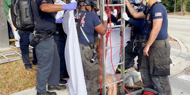 Only a pair of scuffed, bloody knees can be seen on Lyndsey Kennedy, 43, before she’s loaded onto a stretcher en route to a Florida hospital for medical treatment.