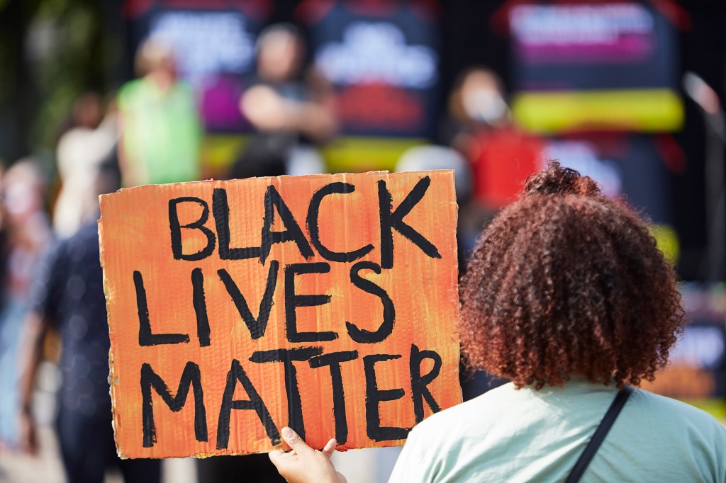 A protester holds a Black Lives Matter sign.