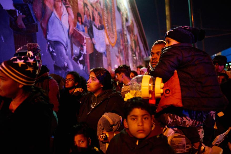 Migrants enter an overnight shelter at Sacred Heart Church.