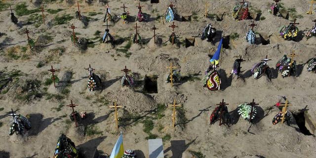 Tombs of people who died after Russia invasion are seen in Bucha cemetery, outskirts of Kyiv, Ukraine, Tuesday, May 24.