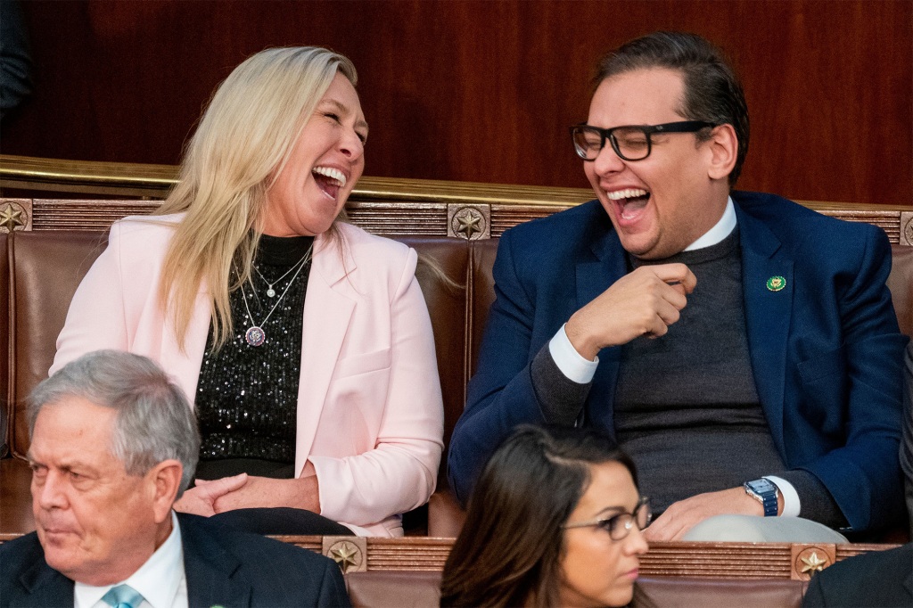 Georgia Rep. Marjorie Taylor Greene laughs with Santos as Representatives try to determine who will become the next Speaker of the House.