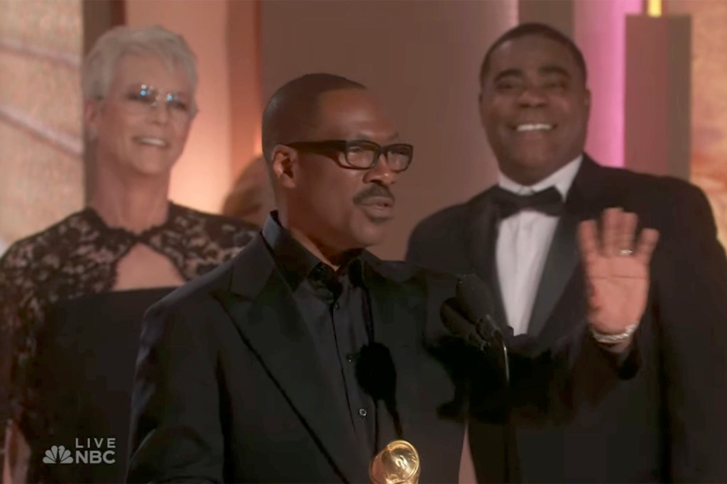 Eddie Murphy accepts his honor as Jamie Lee Curtis and Tracy Morgan look on.