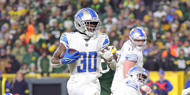 Jamaal Williams of the Detroit Lions rushes for a touchdown during a game against the Green Bay Packers at Lambeau Field Jan. 8, 2023, in Green Bay, Wis. The Lions defeated the Packers 20-16.