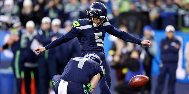 Jason Myers #5 of the Seattle Seahawks kicks the winning field goal against the Los Angeles Rams during overtime to win the game at Lumen Field on January 08, 2023 in Seattle, Washington.