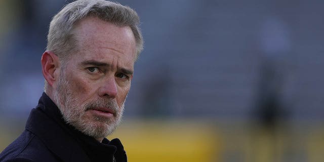 Joe Buck walks across Lambeau Field prior to a game between the Green Bay Packers and Cleveland Browns Dec. 25, 2021, in Green Bay, Wis. 