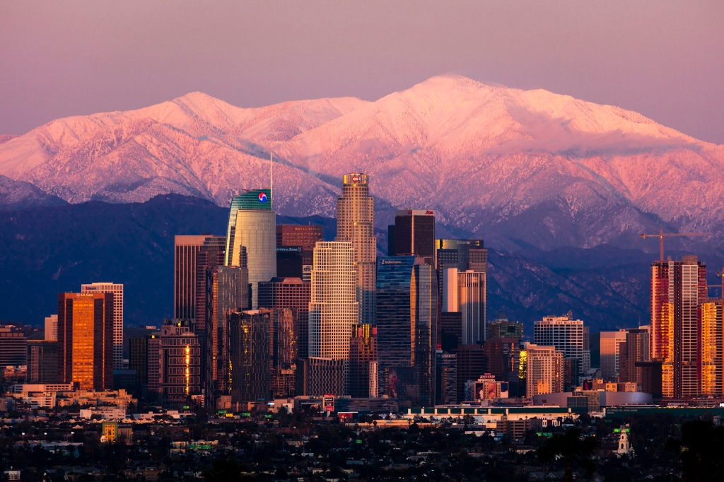 Los Angeles Skyline framed by San Bernadino Mountains and Mount Baldy with fresh snow from Kenneth Hahn State Park/