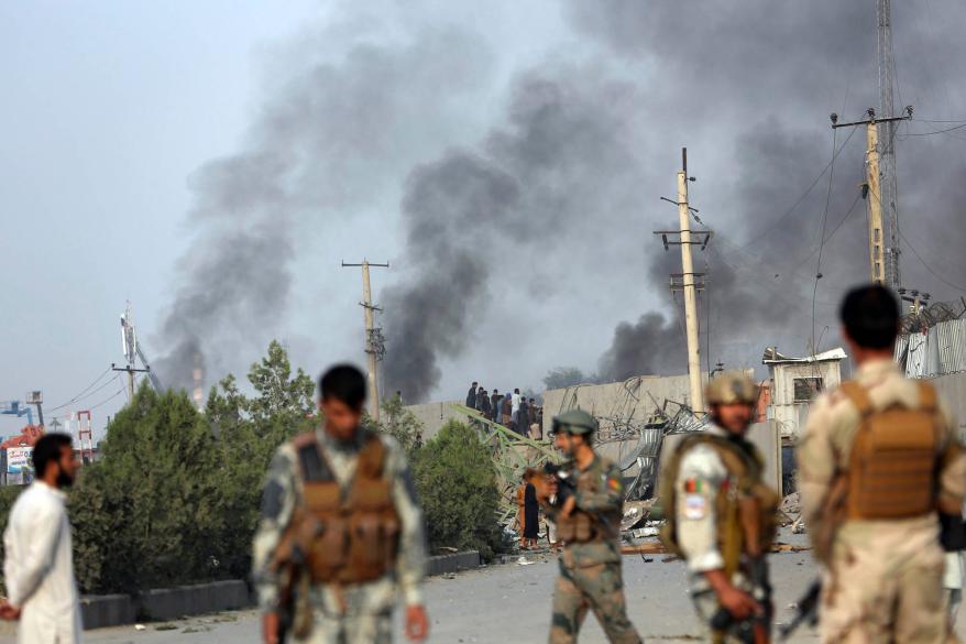 Smoke billows from the Green Village, home to several international organizations and guesthouses, in Kabul.