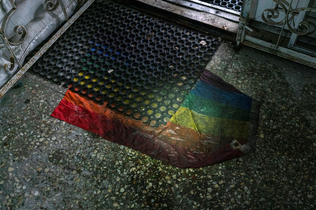 A Gay Pride flag is seen under a rubber mat at an entrance to a basement of an office building in Kherson, where  where prosecutors say 30 people were held for two months.