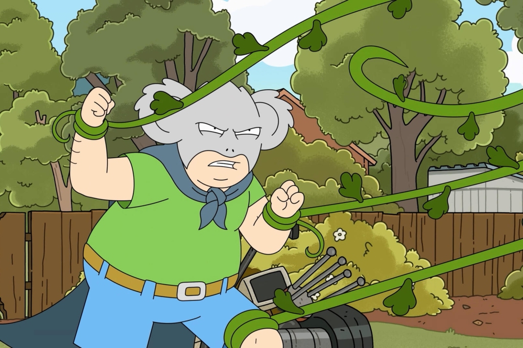 Kevin in action as Koala Man, battling the deadly "Tall Poppy" in the series opener. He's wearing his grey koala man mask, which has grey ears. He's also wearing a cape and has green vines wrapped around his wrists and his knee.