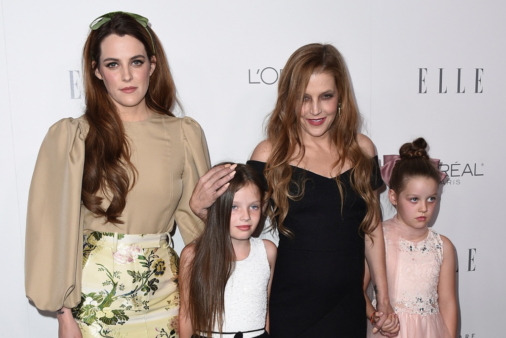 Lisa Marie Presley with her kids, Riley Keogh (left), and twin daughters Finley and Harper Lockwood in 2017, smiling. 