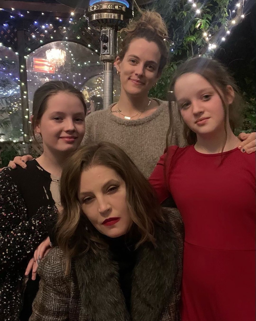 Lisa Marie Presley with her daughters, Riley Keough and twins Harper and Finley, smiling together. 