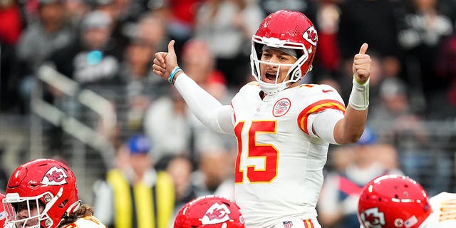 Patrick Mahomes (15) of the Kansas City Chiefs signals at the line of scrimmage against the Las Vegas Raiders during the first half of a game at Allegiant Stadium Jan. 7, 2023, in Las Vegas. 