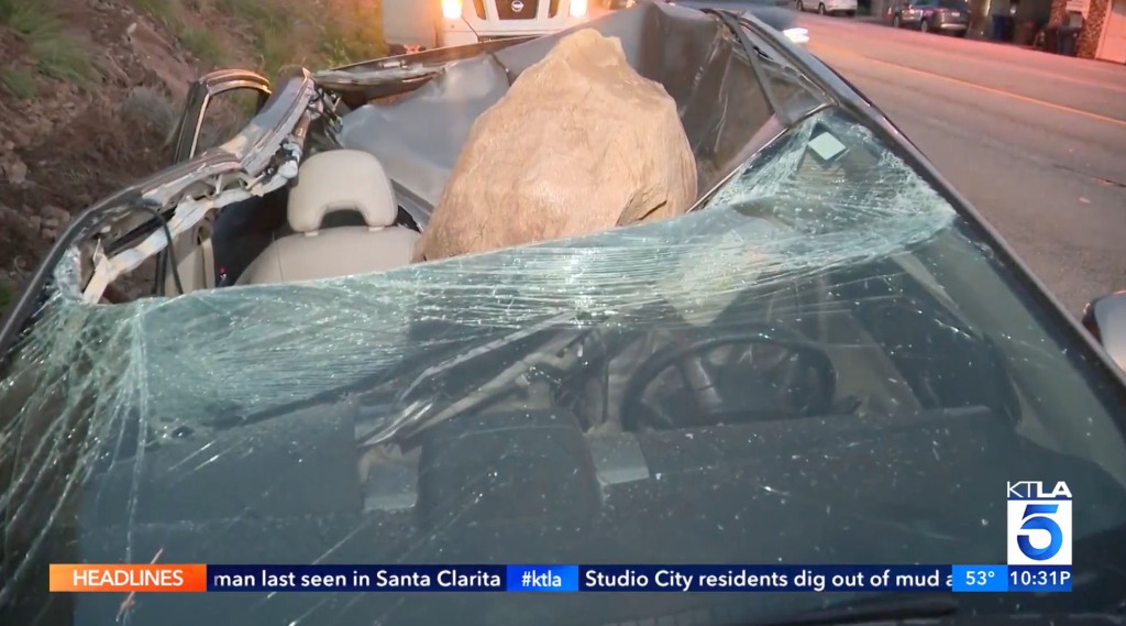 This 4-foot boulder landed directed on Henao's car, completely crushing its roof.