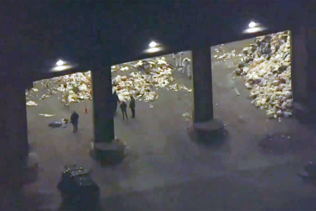 Investigators sorting through trash at a transfer station in Peabody, Mass.