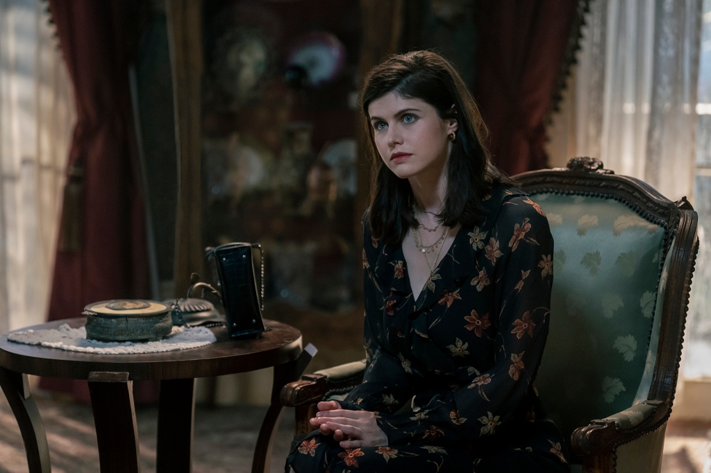 Alexandra Daddario as Dr. Rowan Fielding 
 in "Mayfair Witches" sitting at a desk. 