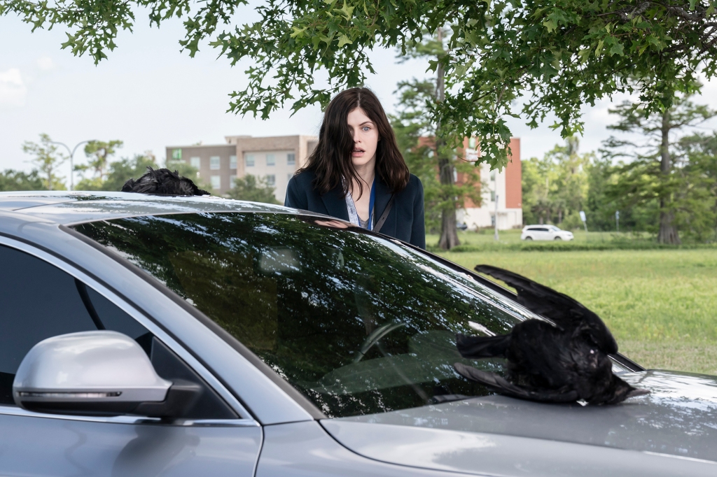 Alexandra Daddario as Dr. Rowan Fielding in "Mayfair Witches" standing by a car looking shocked. 