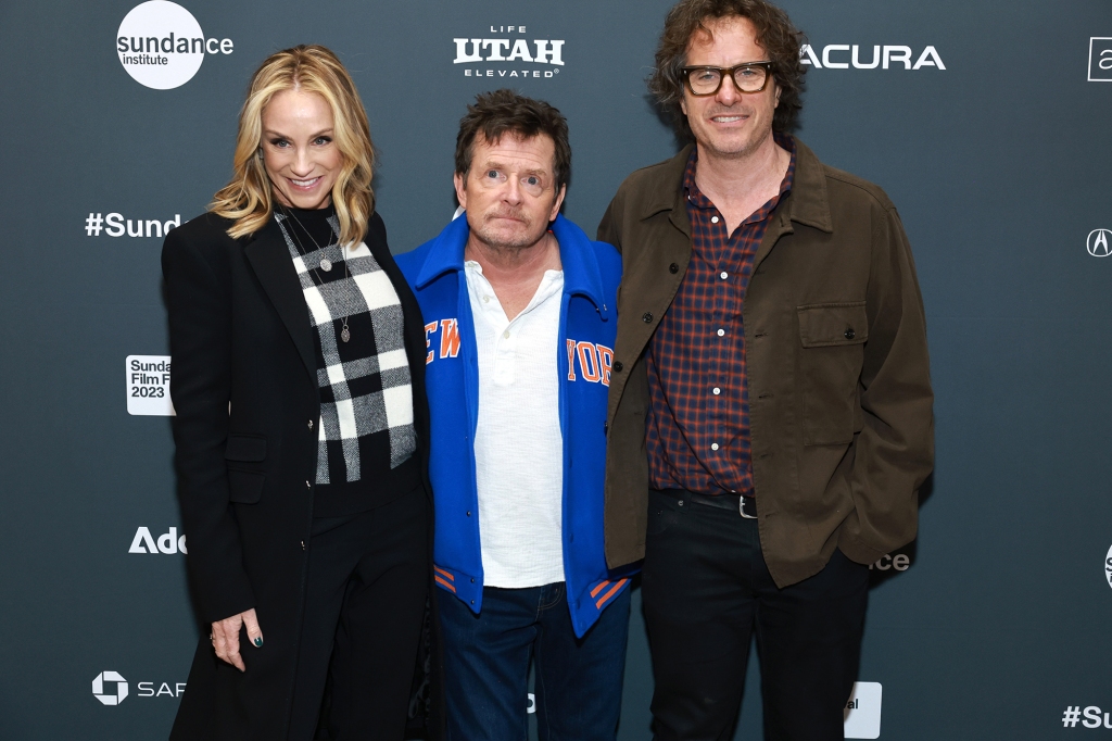 Fox (center), wife Tracy Pollan and director Davis Guggenheim walk the red carpet at Sundance. 