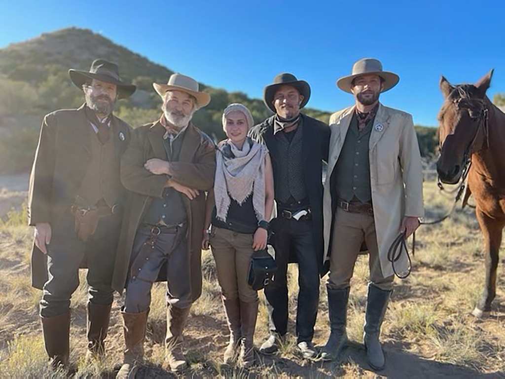 Alec Baldwin posing with Halyna Hutchins and others on the set of "Rust."