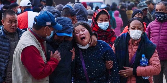 A woman cries as the body of a relative, victim of a plane crash, is brought to a hospital in Pokhara, Nepal, Sunday, Jan. 15, 2023. A plane making a 27-minute flight to a Nepal tourist town crashed into a gorge Sunday while attempting to land at a newly opened airport, killing at least 68 of the 72 people aboard. At least one witness reported hearing cries for help from within the fiery wreck, the country’s deadliest airplane accident in three decades.