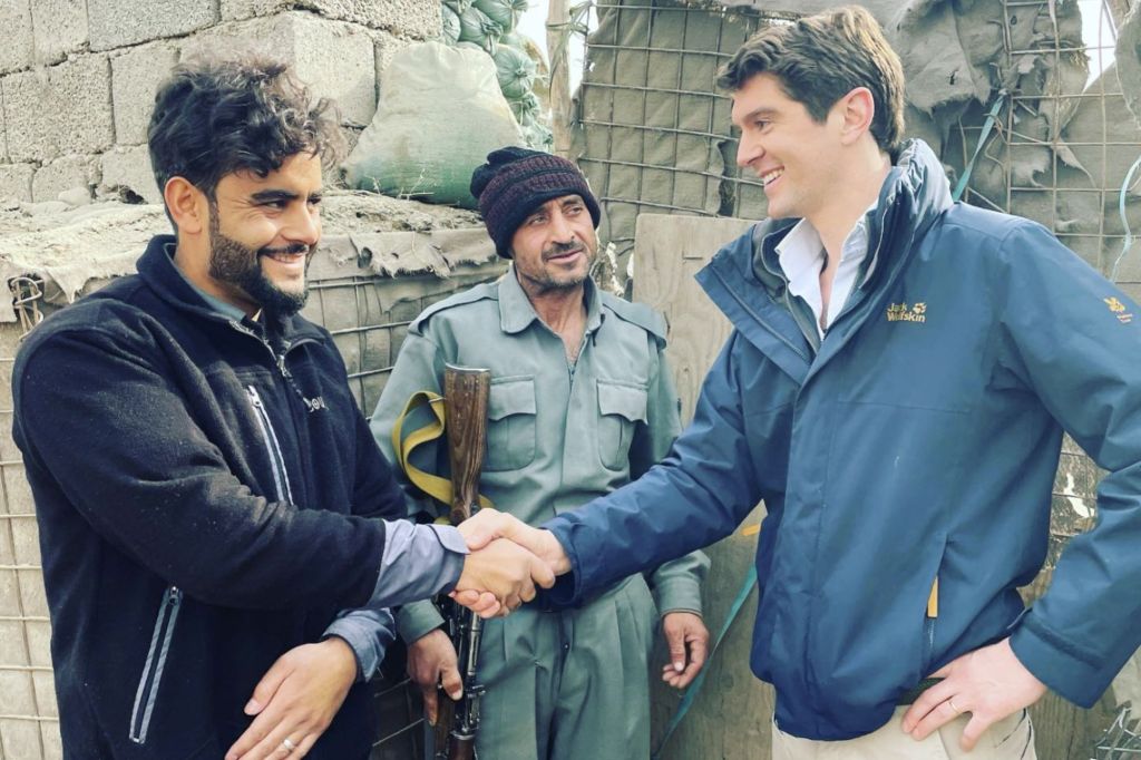 Benjamin Hall is pictured with two people in Kabul, Afghanistan. 