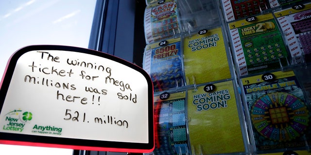 A sign is displayed near scratch-off tickets inside a Lukoil service station where the winning ticket for the Mega Millions lottery drawing was sold, Saturday, March 31, 2018, in Riverdale, N.J.