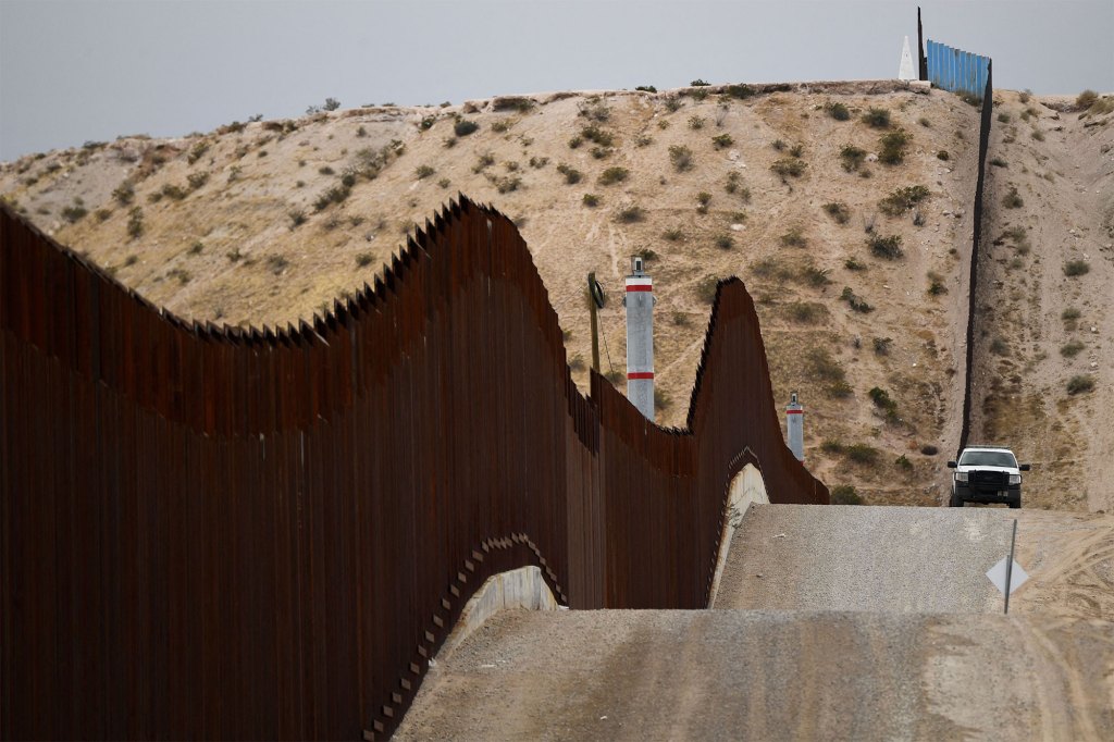 A US Border Patrol vehicle sits next to a border wall in the El Paso Sector along the US-Mexico border between New Mexico and Chihuahua state on December 9, 2021 