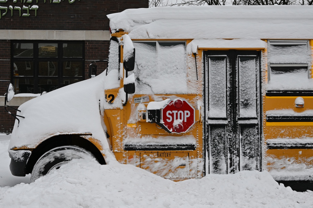 School bus covered in snow.