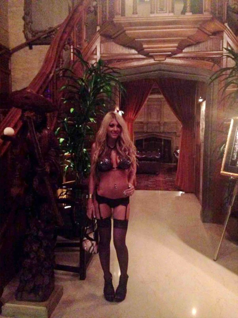 The beauty is seen at Hugh Hefner's home clad in lingerie. She says people were having sex all around the home. 