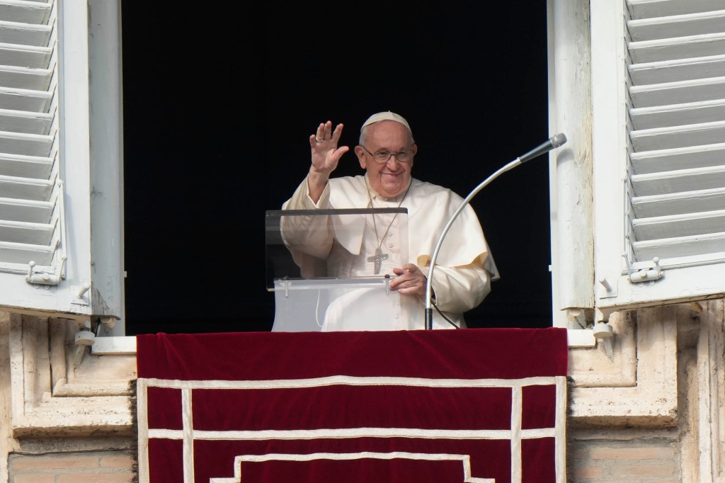 Pope Francis delivers his blessing as he recites the Angelus noon prayer from the window of his studio overlooking St. Peter's Square,.