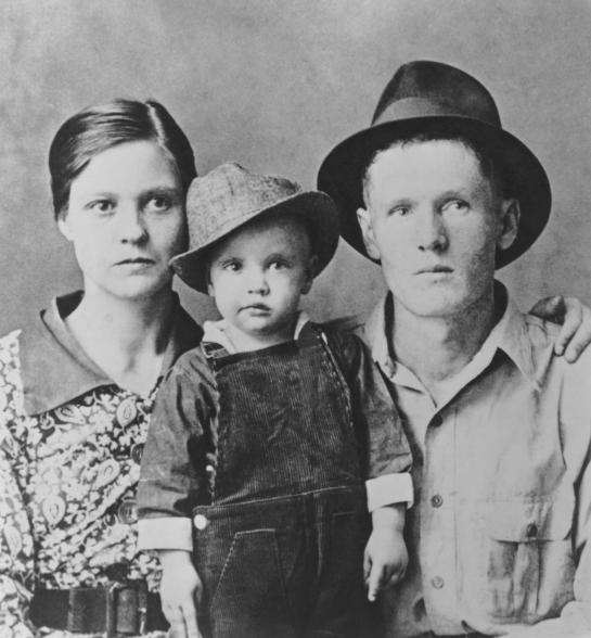 Two year old Elvis Presley poses for a family portrait with his parents Vernon Presley and Gladys Presley in 1937.