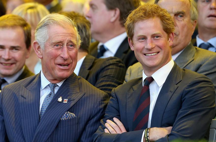 Prince Charles, Prince of Wales and Prince Harry laugh during the Invictus Games Opening Ceremony on September 10, 2014 in London, England.