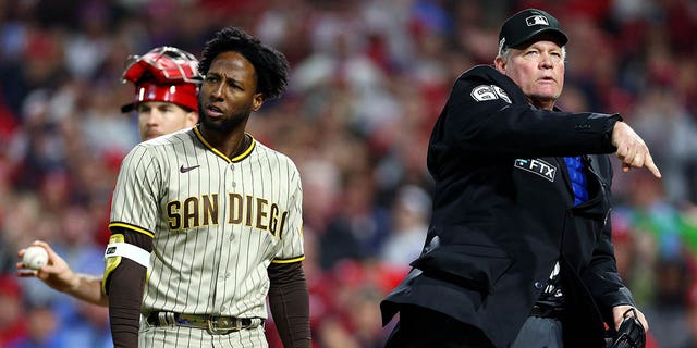 Jurickson Profar #10 of the San Diego Padres is ejected by home plate umpire Ted Barrett after arguing a checked swing call during the ninth inning in game three of the National League Championship Series at Citizens Bank Park on October 21, 2022 in Philadelphia, Pennsylvania.