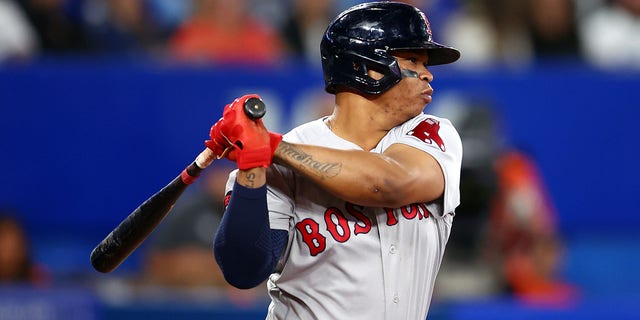 Rafael Devers #11 of the Boston Red Sox bats against the Toronto Blue Jays at Rogers Centre on September 30, 2022 in Toronto, Ontario, Canada. 