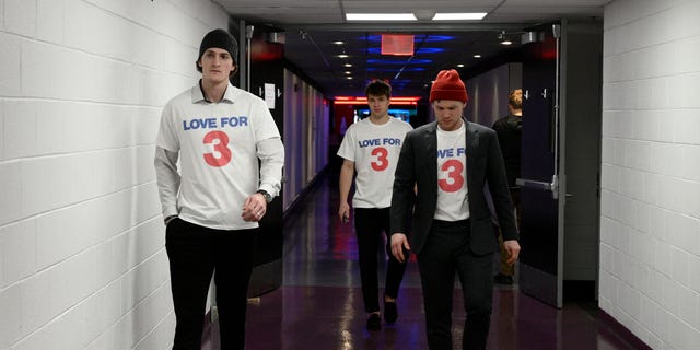 Buffalo Sabres players walk towards the locker room upon arriving wearing shirts in support of Buffalo Bills football player Damar Hamlin before an NHL hockey game against the Washington Capitals, Tuesday, Jan. 3, 2023, in Washington. 